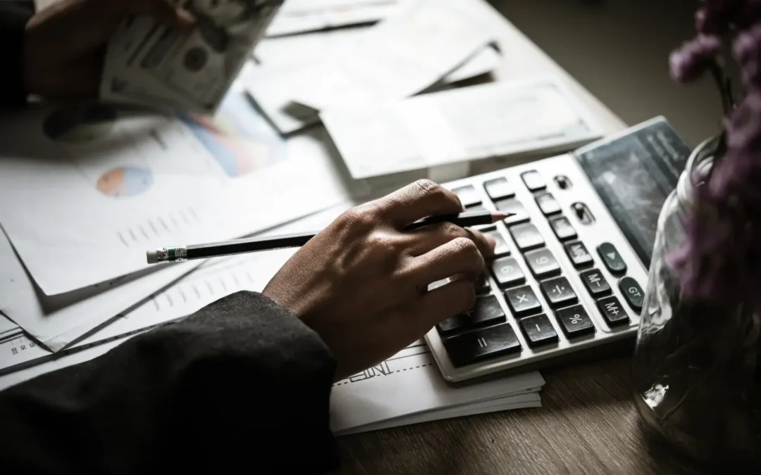 midsection businessman using calculator table